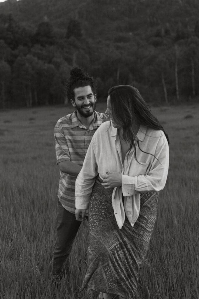 Jessica looking over her shoulder while walking through a field, sunlight hitting her hair