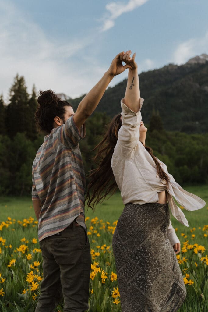 couple dancing in a field of flowers