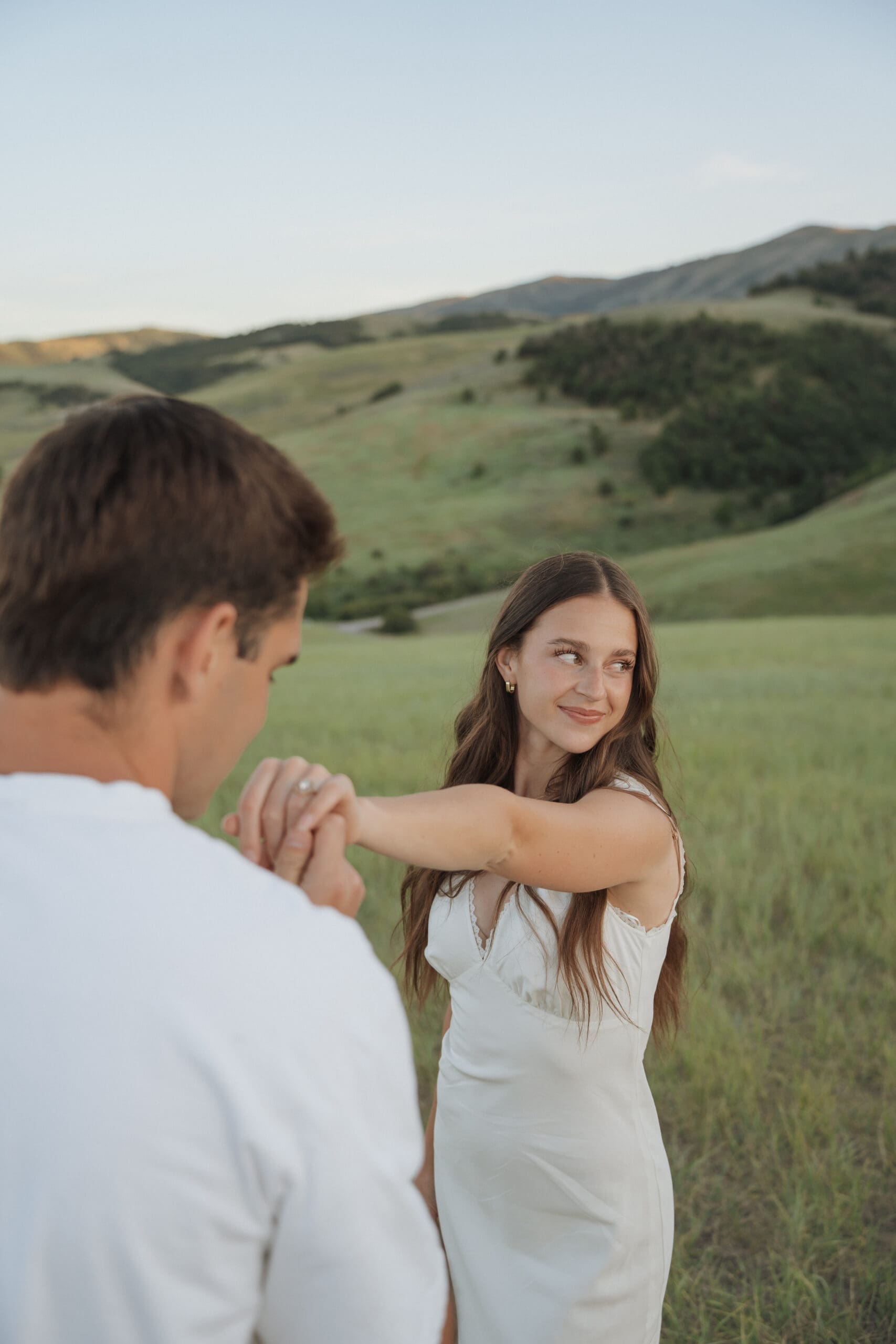 Close-up of couple holding hands in a grassy field, Wellsville engagement photos