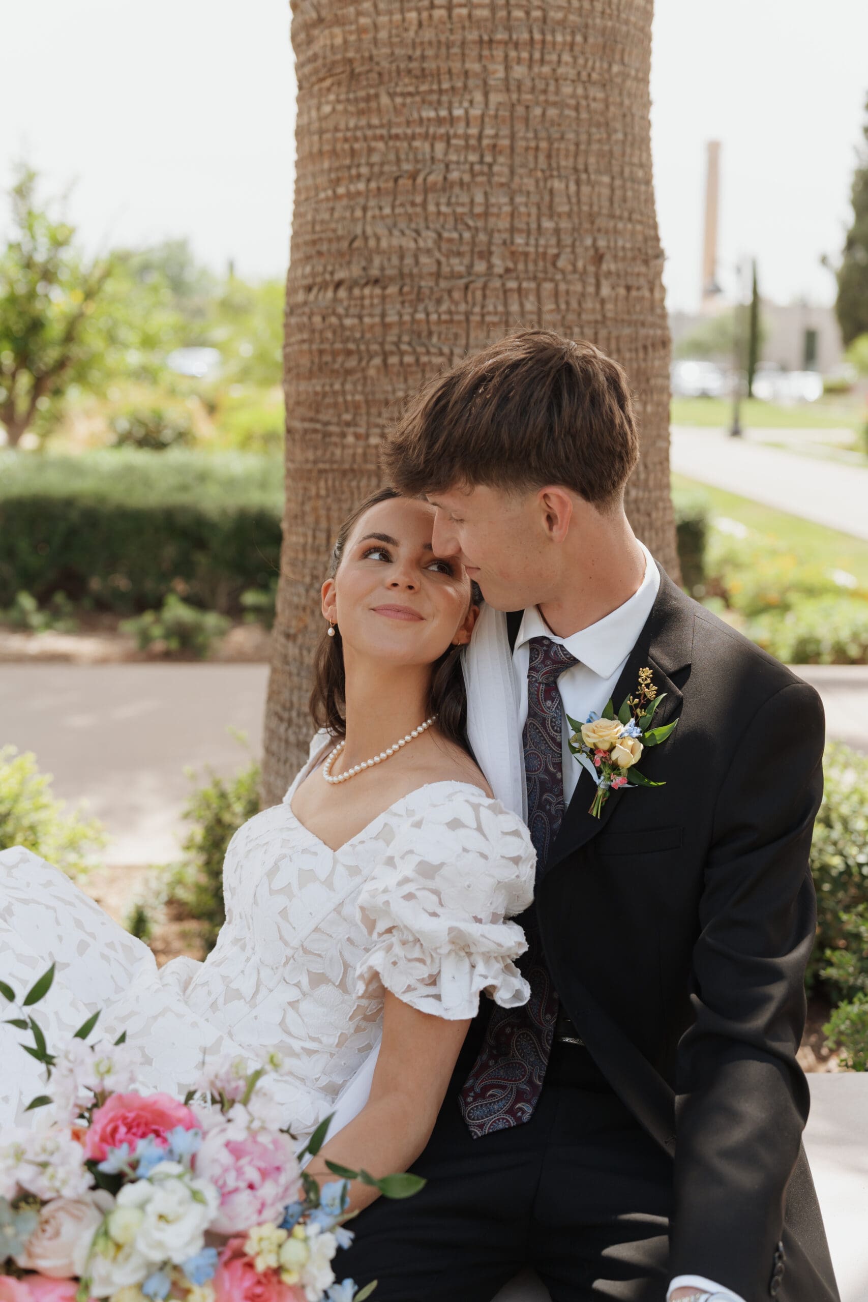 husband and wife share a sweet moment on a bench after their ceremony