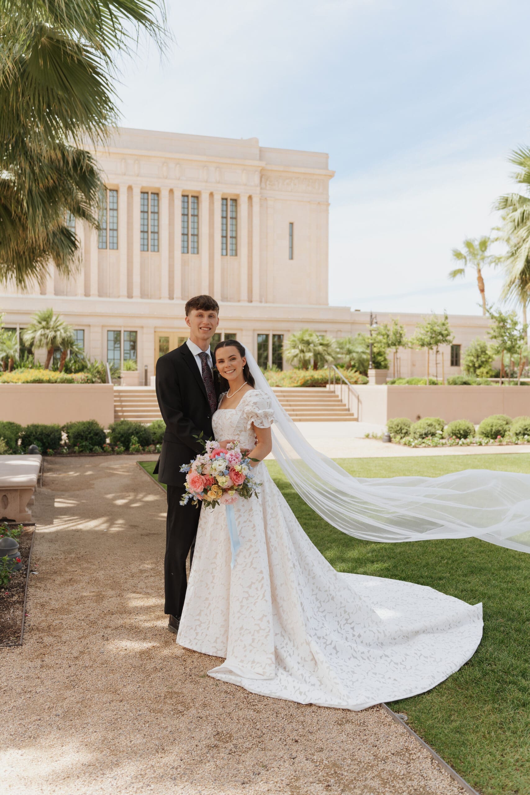 husband and wife in front of mesa temple
