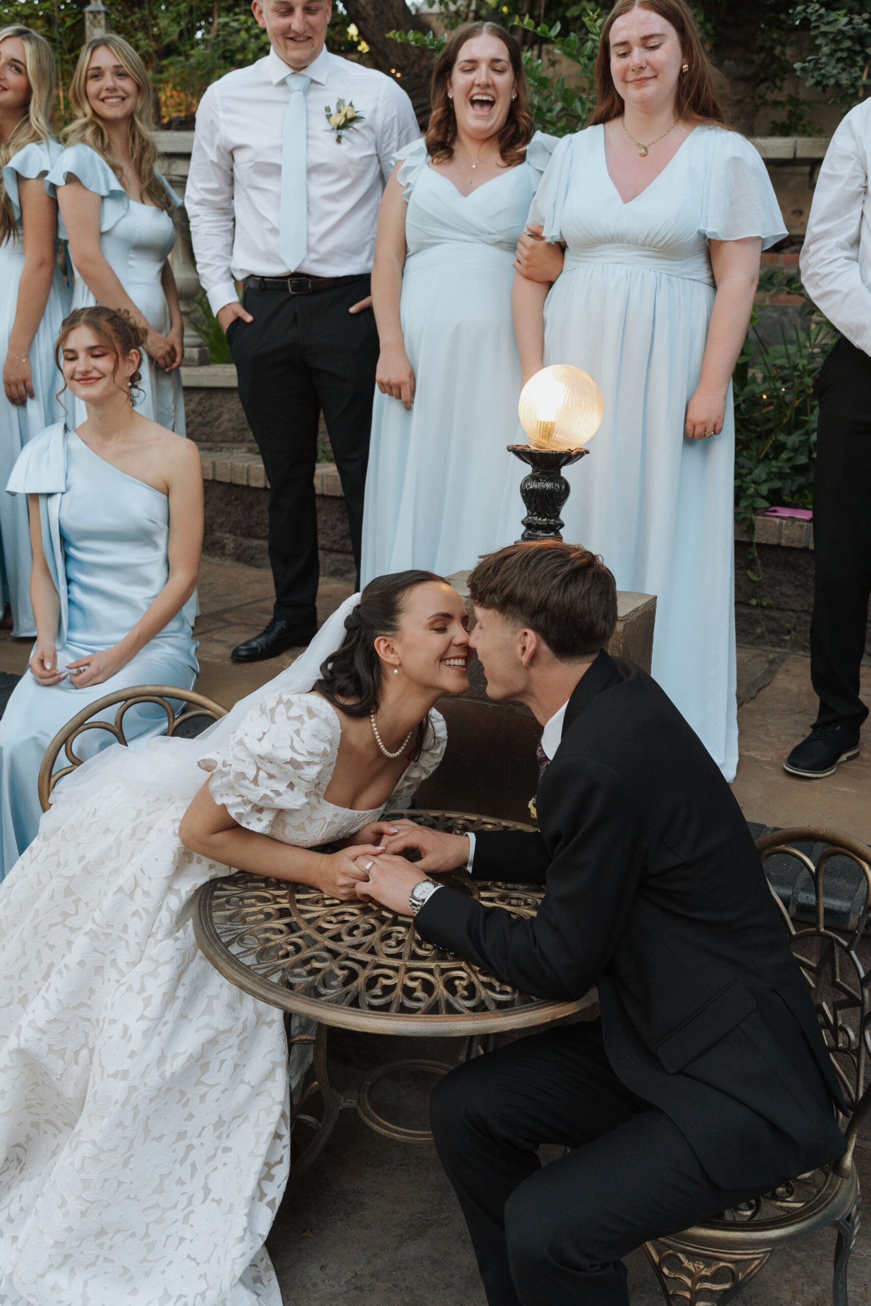 husband and wife kiss at a table