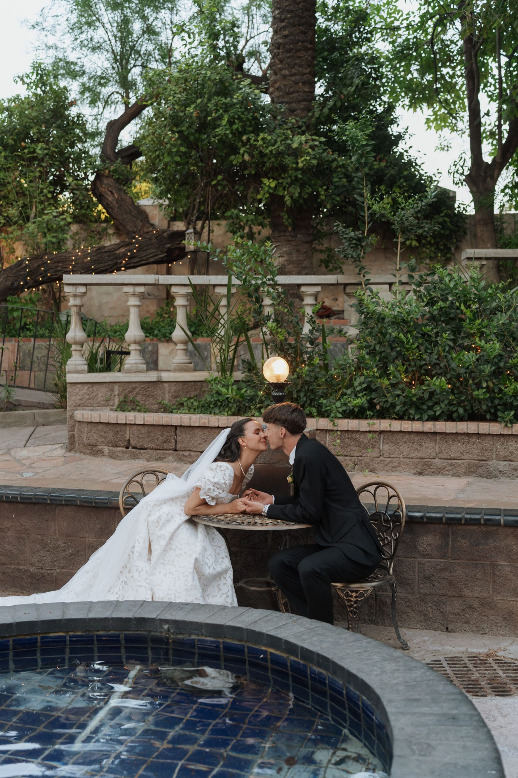 husband and wife kiss at table at the wright house