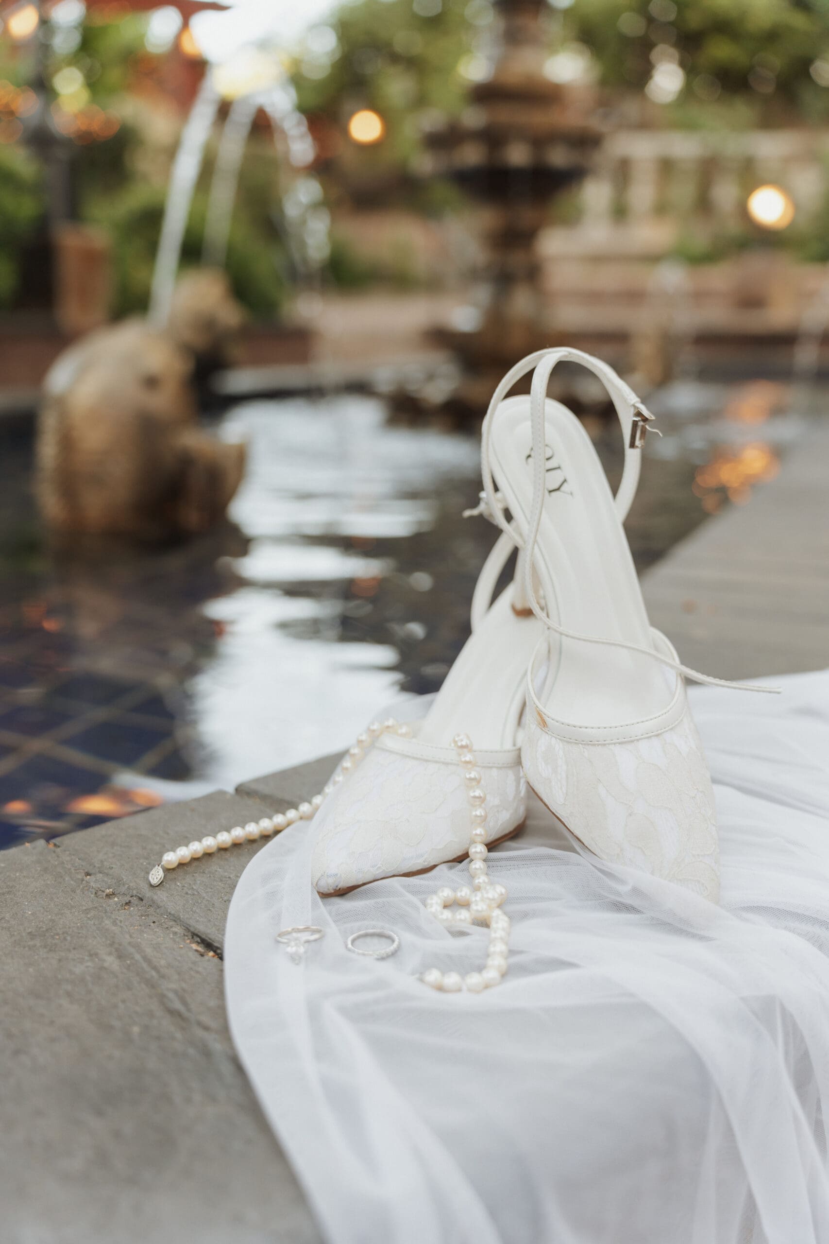 a pair of bridal shoes along a poolside