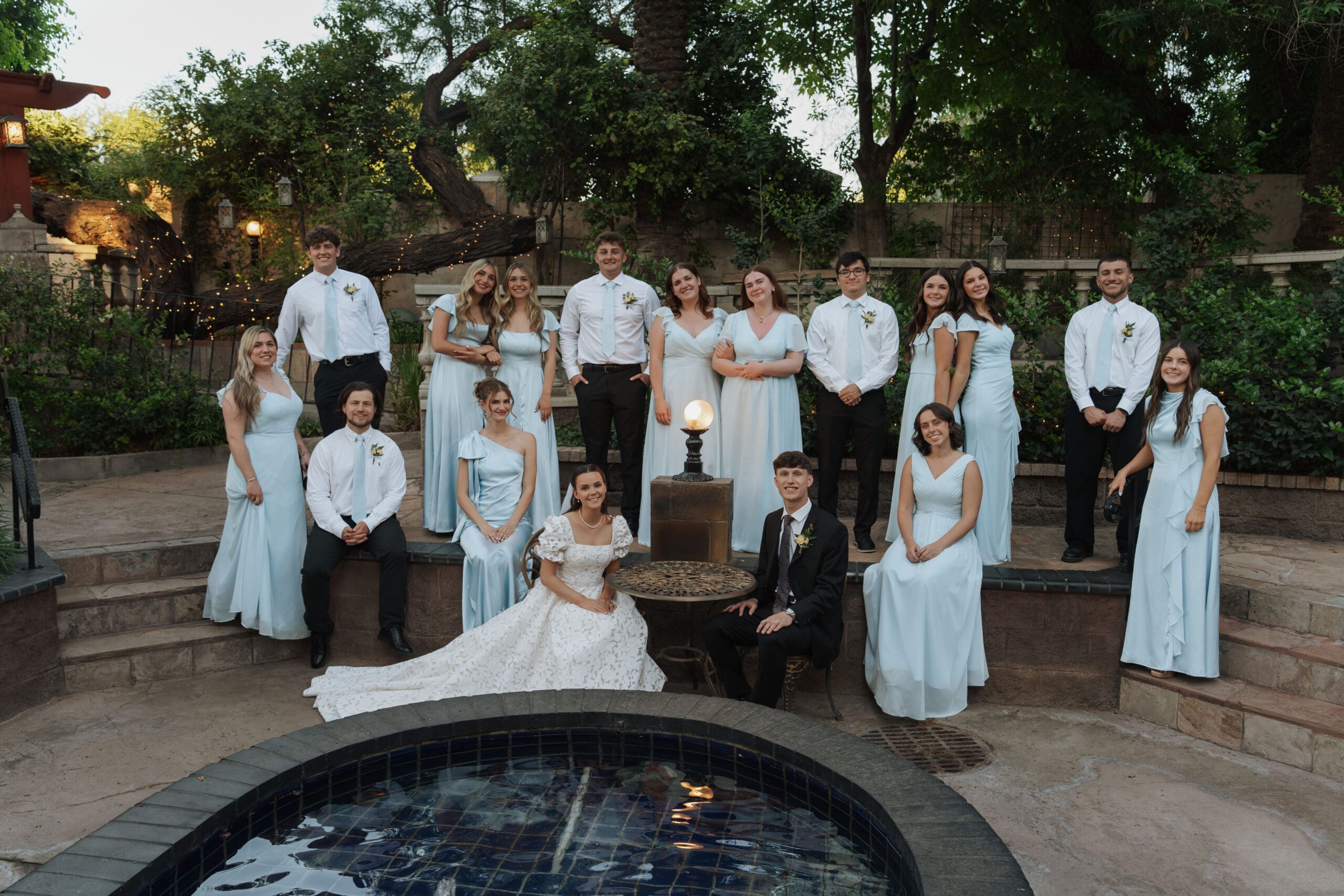 A large group of bridesmaids and groomsmen posing together